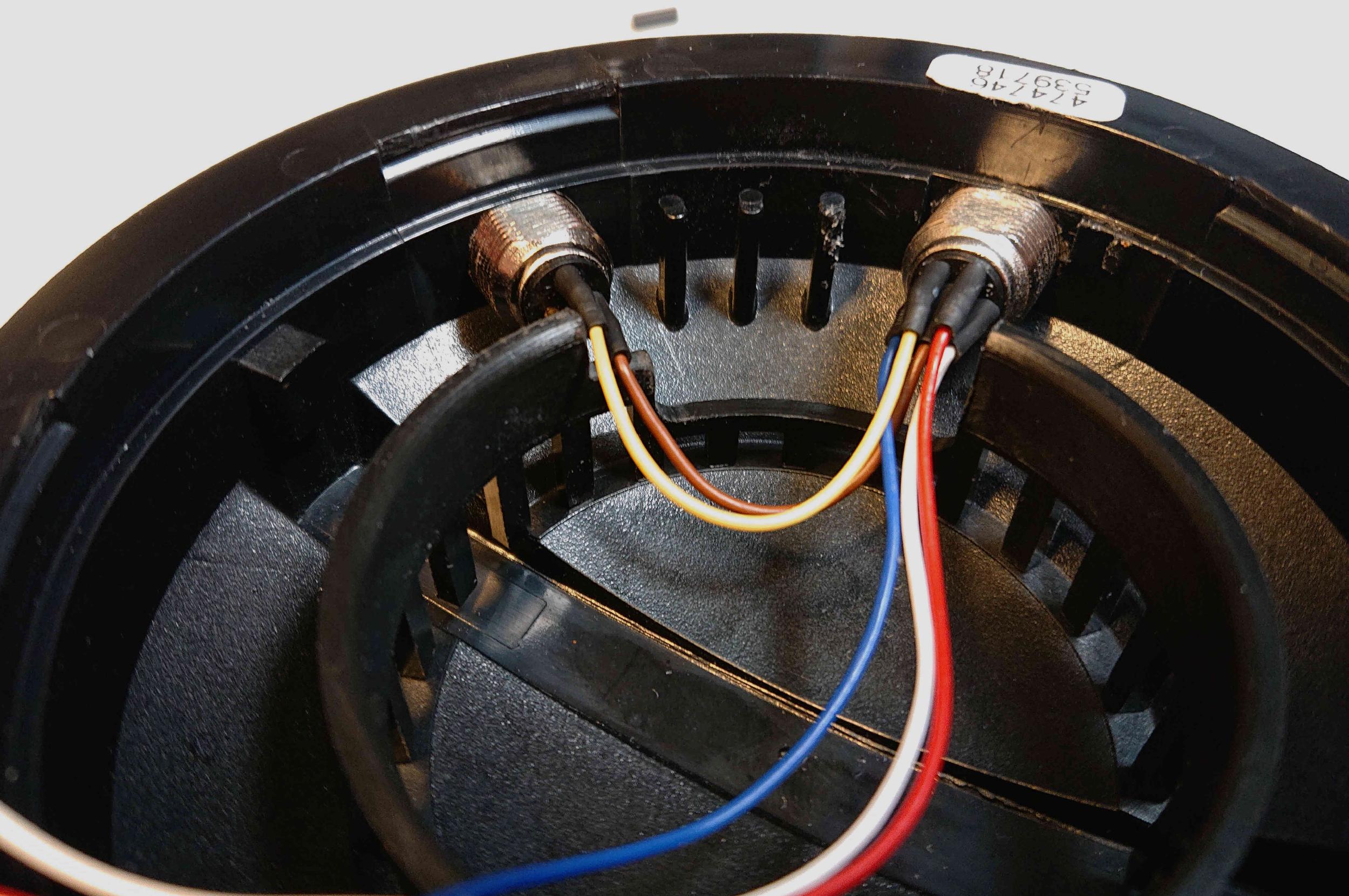 Coloured wires attached to two sockets inside the ear cup